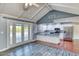 Open concept kitchen with white cabinets, stainless steel appliances and direct access to the outdoor pool at 1556 E Dover Cir, Mesa, AZ 85203