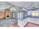 Open-concept living area connecting the kitchen and featuring a brick fireplace at 1556 E Dover Cir, Mesa, AZ 85203
