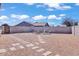 Gravel backyard features stepping stones, seating and a fire pit, creating a welcoming outdoor living space at 15814 N 62Nd Cir, Glendale, AZ 85306