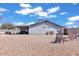 Spacious backyard featuring desert landscaping, covered patio, and outdoor seating areas at 15814 N 62Nd Cir, Glendale, AZ 85306