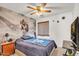 Bedroom showcasing a unique mural, wooden accents, and a functional workspace at 15814 N 62Nd Cir, Glendale, AZ 85306
