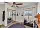 Well-lit bedroom featuring a ceiling fan, closet with mirrored doors, and comfortable furnishings at 15814 N 62Nd Cir, Glendale, AZ 85306