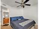 Bedroom featuring a bed with blue pillows and linens, complemented by a ceiling fan at 15814 N 62Nd Cir, Glendale, AZ 85306
