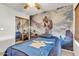 Bedroom showcasing a Star Wars mural and decor, complemented by warm lighting at 15814 N 62Nd Cir, Glendale, AZ 85306