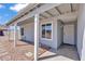 Charming entryway with desert landscaping, a covered porch, and a secure front door at 15814 N 62Nd Cir, Glendale, AZ 85306