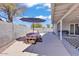 Outdoor patio featuring a picnic table with an umbrella, creating a comfortable area for dining and relaxation at 15814 N 62Nd Cir, Glendale, AZ 85306