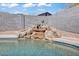 Backyard pool with custom rock waterfall feature for a tranquil and aesthetic outdoor space at 15814 N 62Nd Cir, Glendale, AZ 85306