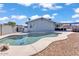 Backyard pool features a unique design, with coping and patio area, perfect for relaxation and outdoor enjoyment at 15814 N 62Nd Cir, Glendale, AZ 85306