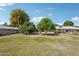 Large backyard space featuring mature trees, manicured lawn and a private patio at 17885 N 99Th Dr, Sun City, AZ 85373