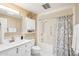 Bright bathroom with white cabinets and a shower-tub combination at 17885 N 99Th Dr, Sun City, AZ 85373