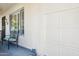 Inviting covered porch with bench seating next to the front door and a view to the garage door at 17885 N 99Th Dr, Sun City, AZ 85373