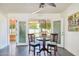 Bright dining area featuring tile floors, ceiling fan, and access to outdoor space at 17885 N 99Th Dr, Sun City, AZ 85373
