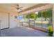 Relaxing enclosed patio with ceiling fan and outdoor access, perfect for enjoying the backyard and fresh air at 17885 N 99Th Dr, Sun City, AZ 85373