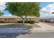 Charming single-story home features a manicured front yard with mature trees and a private driveway at 17885 N 99Th Dr, Sun City, AZ 85373