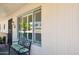 Cozy front porch with a wrought iron bench, offering a relaxing space with ample natural light and charming details at 17885 N 99Th Dr, Sun City, AZ 85373