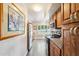 Galley kitchen features stainless steel appliances, tile floors, and wooden cabinets at 17885 N 99Th Dr, Sun City, AZ 85373