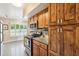 Updated kitchen features wooden cabinets, granite countertops, and modern appliances at 17885 N 99Th Dr, Sun City, AZ 85373
