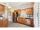 Well-lit kitchen showcasing stainless steel appliances, wooden cabinetry, tile backsplash, and modern track lighting at 17885 N 99Th Dr, Sun City, AZ 85373