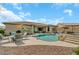 Enjoy entertaining in this large backyard with a pool, rock features, and desert landscaping at 18120 W Cassia Way, Goodyear, AZ 85338