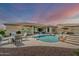 A beautiful backyard with a pool, rock features, spa, patio, and lounge area is perfect for relaxation and outdoor entertaining at 18120 W Cassia Way, Goodyear, AZ 85338