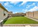 This is a long backyard with desert landscaping and a patch of artificial turf at 18120 W Cassia Way, Goodyear, AZ 85338