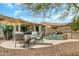 Entertain in this backyard with a pool, waterfall, covered patio, outdoor kitchen and desert landscaping at 18120 W Cassia Way, Goodyear, AZ 85338