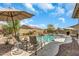 Enjoy the spacious backyard with a sparkling pool, rock features, and desert landscaping at 18120 W Cassia Way, Goodyear, AZ 85338