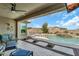 Luxurious outdoor space with a sparkling pool, covered patio, and seating area for relaxation and entertainment at 18120 W Cassia Way, Goodyear, AZ 85338