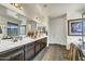 Bathroom showcases double sinks, stylish vanity, and access to shower and tub at 18120 W Cassia Way, Goodyear, AZ 85338