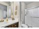 Well-lit bathroom showcasing a large mirror, toilet, and modern glass-enclosed shower at 18120 W Cassia Way, Goodyear, AZ 85338