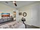 This inviting bedroom features soft colors, comfortable furnishings, and a ceiling fan for added comfort at 18120 W Cassia Way, Goodyear, AZ 85338