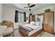 Bright bedroom with window, closet, and a crib adjacent to the bed at 18120 W Cassia Way, Goodyear, AZ 85338