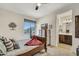 Cozy bedroom with a TV, dresser, and a doorway leading to a bathroom at 18120 W Cassia Way, Goodyear, AZ 85338