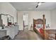 Bedroom with a decorative bed frame, dresser, and a doorway leading to another room at 18120 W Cassia Way, Goodyear, AZ 85338