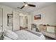Bedroom with a crib and television, and an open door leading to another room at 18120 W Cassia Way, Goodyear, AZ 85338