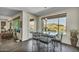 Dining area features a modern table set and offers views of the pool and outdoor space at 18120 W Cassia Way, Goodyear, AZ 85338