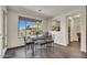 The dining area features natural lighting and a modern table set, adjacent to an open living space at 18120 W Cassia Way, Goodyear, AZ 85338