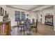 Formal dining area with a chandelier, a glass table, and a decorative accent wall at 18120 W Cassia Way, Goodyear, AZ 85338