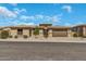 A desert home featuring desert landscaping and a three-car garage on a sunny day at 18120 W Cassia Way, Goodyear, AZ 85338