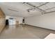 Spacious three car garage with epoxy floors and built-in storage cabinets, offering ample parking at 18120 W Cassia Way, Goodyear, AZ 85338
