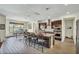 Open kitchen area boasts a large island with seating, stainless appliances and adjacent dining area at 18120 W Cassia Way, Goodyear, AZ 85338