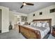 The main bedroom features a decorative ceiling fan and a cozy sitting area visible through the doorway at 18120 W Cassia Way, Goodyear, AZ 85338