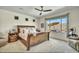 Serene main bedroom features a large sleigh bed and a window view of the outdoor living space at 18120 W Cassia Way, Goodyear, AZ 85338