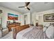Spacious bedroom includes dresser, television, and a doorway leading to the Primary bath at 18120 W Cassia Way, Goodyear, AZ 85338