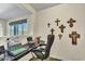Home office featuring a built-in desk, comfortable chair, and wall decorations at 18120 W Cassia Way, Goodyear, AZ 85338