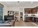 Combination office nook with dark wood cabinets and a nearby lounge area with bookshelves at 18120 W Cassia Way, Goodyear, AZ 85338