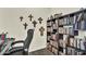 Office space with built-in shelving for books and decor, with natural lighting, and neutral wall color at 18120 W Cassia Way, Goodyear, AZ 85338