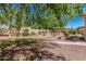 Spacious backyard with desert landscaping, pergola, and green grass area at 1834 E Scorpio Pl, Chandler, AZ 85249