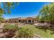 Well maintained backyard with green grass, desert landscaping and patio covering at 1834 E Scorpio Pl, Chandler, AZ 85249
