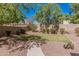 Manicured backyard with desert landscaping, pavers, and small grass area at 1834 E Scorpio Pl, Chandler, AZ 85249